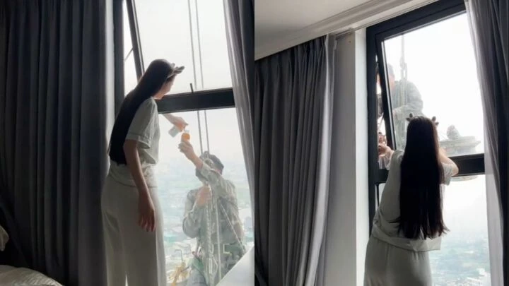 Mát lòng cảnh cô gái mời nước anh thợ treo mình giữa trời nóng lau kính cao ốc Mát lòng cảnh cô gái mời nước anh thợ treo mình giữa trời nóng lau kính cao ốc