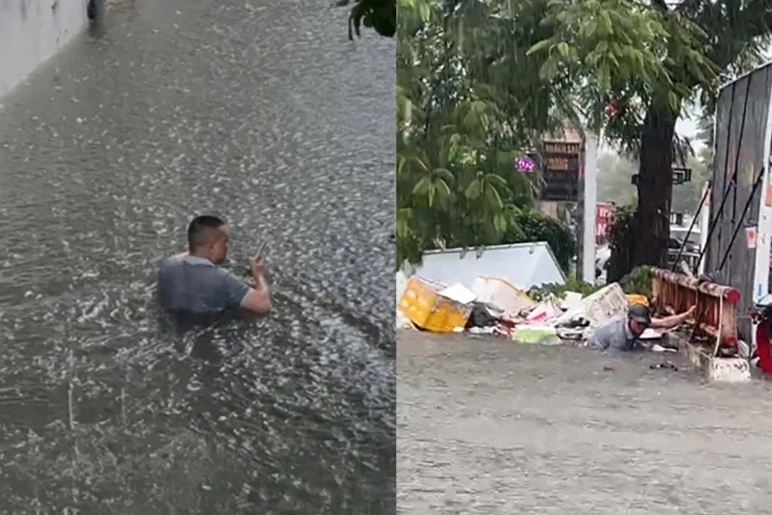Lội nước ngập ngang cổ, đu thành cầu moi rác trong trận mưa lịch sử Lội nước ngập ngang cổ, đu thành cầu moi rác trong trận mưa lịch sử
